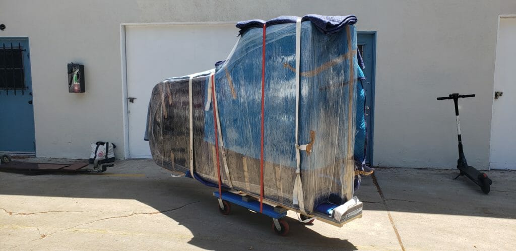 Wrapped grand piano ready for moving