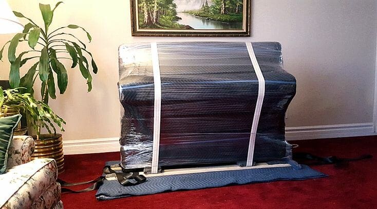 Wrapped upright piano ready for moving